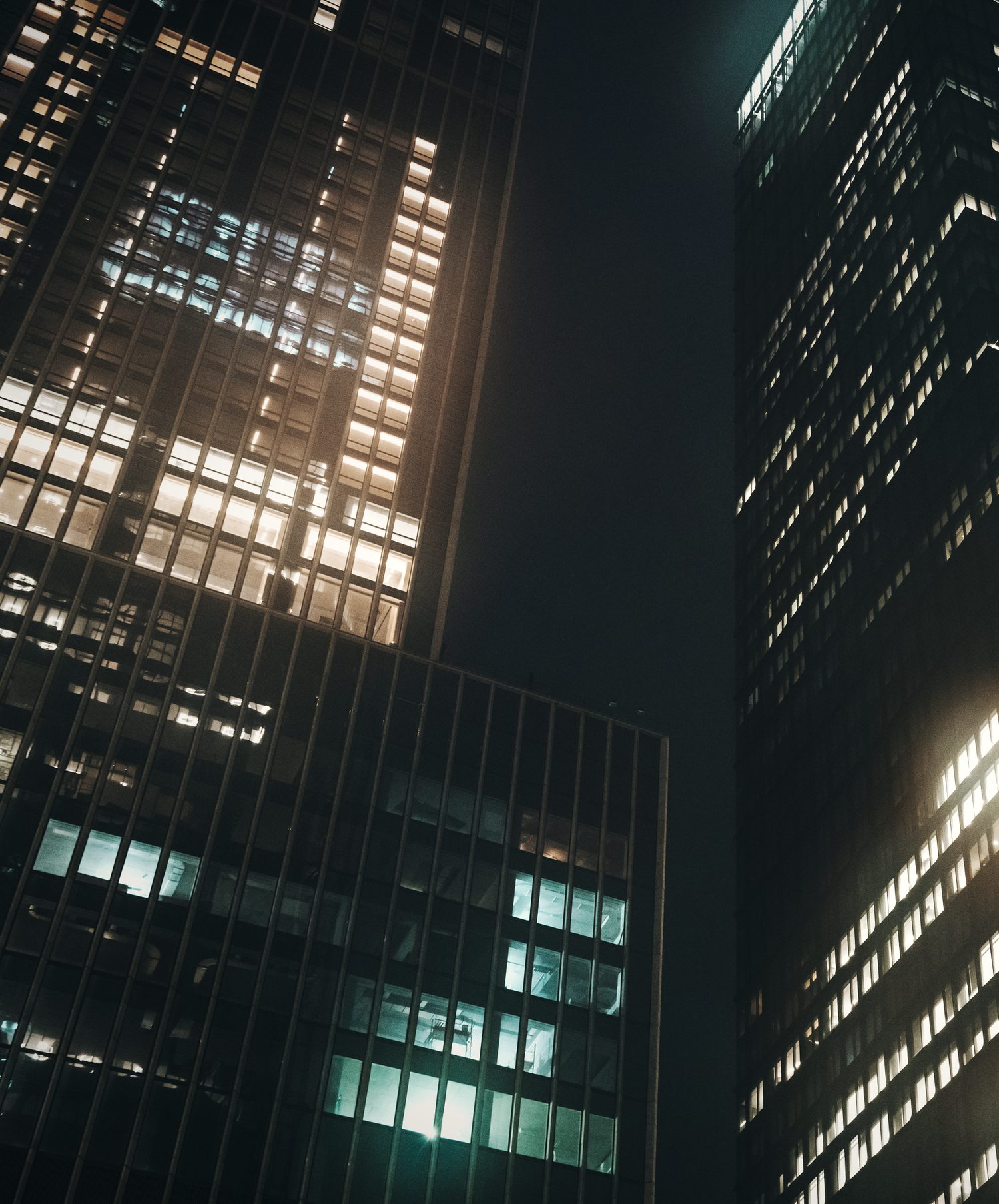 Skyline of lit towers after dark