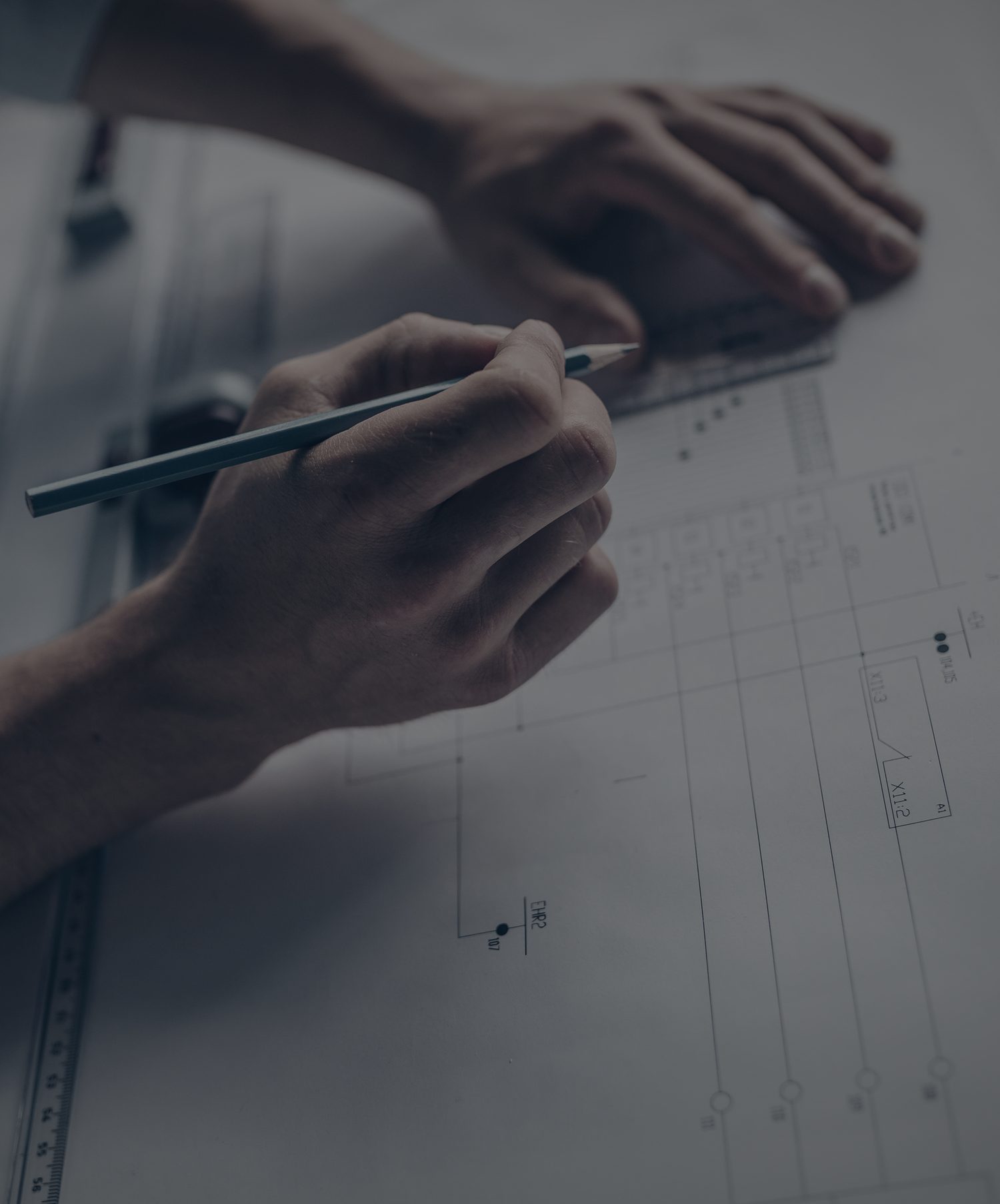 Hands drafting technical blueprints